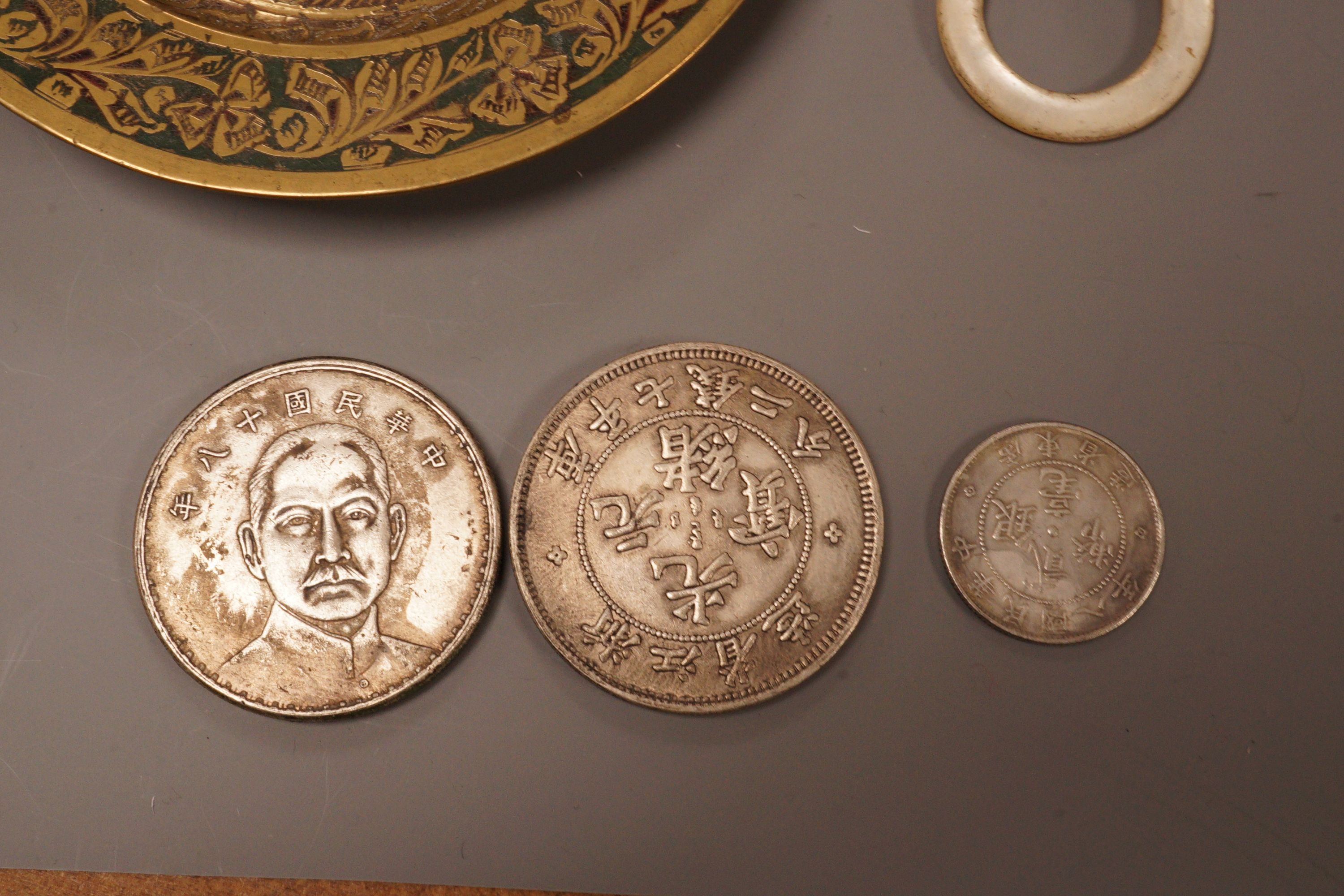 A brass tray, various coins and a rattle dish, 11.5cm diameter